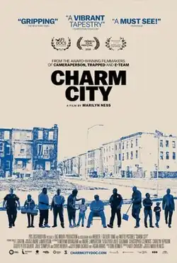 Poster for the documentary film Charm City directed by Marilyn Ness. The design features a stylized blue and beige color scheme, depicting a row of rundown Baltimore row houses in the background. In the foreground, a diverse group of people, including police officers, community members, and children, stand side by side. The title is prominently displayed in bold black letters, with accolades from various film festivals and reviews describing the film as "gripping" and "a must-see".