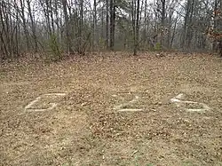 Stone markings at the base of the tower spelling out G-26