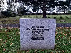 Memorial stone indicating the cemetery contains 4,836 graves of German soldiers from World War II