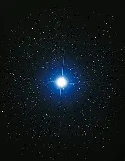 The star Sirius. It is shown as blue and is significantly larger and brighter than surrounding stars.