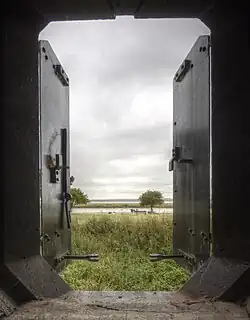 View from within a casemate showing the river, trees and grassy ground