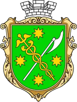 Vert bordure or, a caduceus or and an axe argent saltirewise, four octagrams or in chief, in base and in fess, and overall surmounted by a mural crown argent.