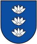 A coat of arms depicting three white flowers lined up vertically with four yellow seeds surrounding each all on a blue background