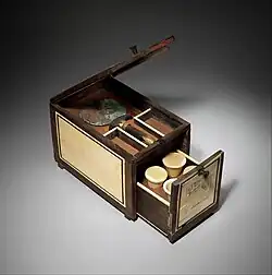 Cosmetic Box of the Royal Butler Kemeni; 1814–1805 BC; cedar with ebony, ivory veneer and silver mounting; height: 20.3 cm (8.0 in); Metropolitan Museum of Art (New York City)