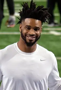 Darius Slay from about the chest up in a white shirt and big smile.