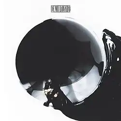 Lovato sitting in a sphere with black liquid coming out of it