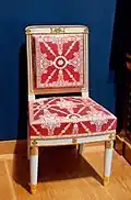 Chair; before 1810; white trimmed wood with gilt carved decoration, modern trim, red and white silk; 90 x 50.5 x 44 cm; Louvre[15]