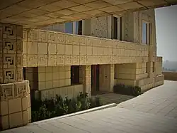 View of the main house from under the footbridge connecting the main house and garage wing, looking south toward Downtown Los Angeles