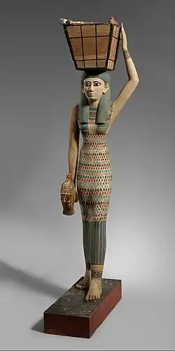 Figurine of a female servant carrying provisions; 1981–1975 BC; painted wood and gesso; 112 × 17 cm; Metropolitan Museum of Art (New York City)