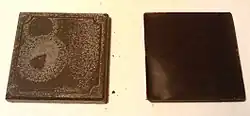 Two squares of chocolate; the left square has a whitish coating