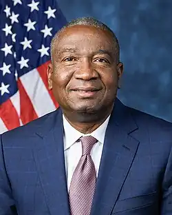 Official House portrait of Fields smiling in front of the U.S. flag, wearing a dark blue suit, white shirt, and checkered red and blue tie.