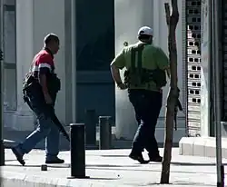 Armed Lebanese militiamen wearing locally produced Ephod Combat Vests running for cover near the Crown Plaza Hotel on the Hamra district in Beirut during the 2008 Lebanon conflict.