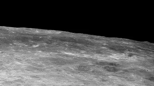 Oblique view with Firsov at center and high-albedo swirls in middle foreground, from Apollo 11