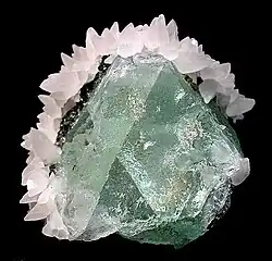Green fluorite framed by white calcite, Naica Mine, mined in the 1980s. Size: 5.5 cm × 5.1 cm × 4.4 cm (2 in × 2 in × 1 in).