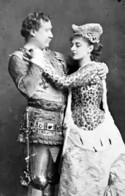 man in medieval armour embracing women in medieval costume