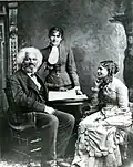 Frederick Douglass with his second wife Helen Pitts Douglass and her sister (standing), c. 1884