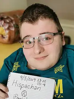 Fredrick Brennan, holding a piece of paper with the handwritten text: "9/5/2019 08:00 UTC+8 Hispachan ñ ¡Pregúntame lo que quieras!"