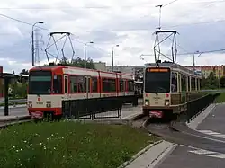 Two three-section trams, the centre sections have no doors