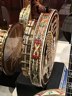 Decorated back and side of a Gibson All American banjo (1969). Highly decorated with carvings, engravings and gold