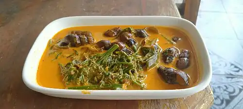 Gulai tekuyung dengan sayur pakis, a traditional Jambi gulai made with river snails and fiddlehead ferns