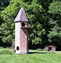 Brick tower with narrow wooden stair spiraling up the side