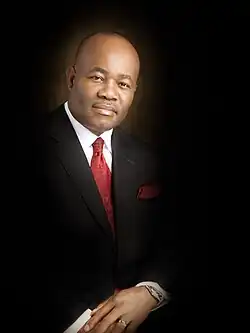 A portrait of Godswill Obot Akpabio on a black suit