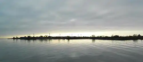 Gråen in January 2018, seen from a quay at Landskrona harbour. The wind turbines are located around "the Plaster Island", the small tower to the right is from the 18th century and is called "Kruttornet" ("the Gun Powder tower")