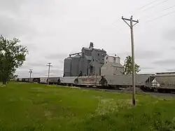 The town's grain elevator, with a DMVW train parked at the terminal in the foreground