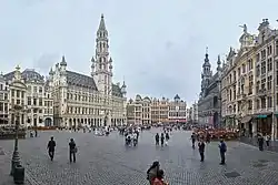 A cobblestone square surrounded by opulent multi-story buildings
