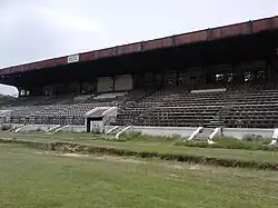 Large, disused grandstand with the letters RCTC on the roof