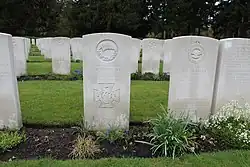 A colour photograph of several grave headstones, with Ward's in the middle of the image