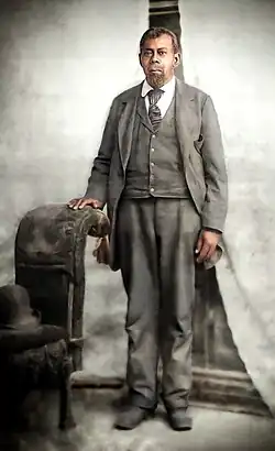 Formal, colorized photo of a standing Green Flake