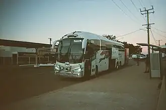 A Greyhound bus pauses in Hughenden at dusk, halfway through its 11 hour journey from Mount Isa to Townsville (One driver finishes their shift and another takes over at this stop)