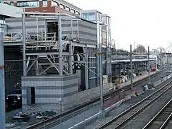 A light rail station being constructed in a railway cut