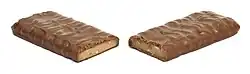 A toffee chocolate candy bar, unwrapped and cut in half