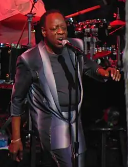 Fambrough singing into a microphone onstage
