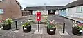 Hillend Main Street post box and flower display.