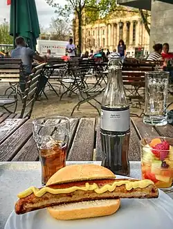 German Hot Dog version served here in Berlin, Germany. In Germany, such sausages are heated in a kettle of hot broth, but are also often grilled, then served in a crunchy bun. The German term for this grilled street food is "Bockwurst" or "Bratwurst im Brötchen."