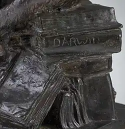 Detail showing pile of books and "Darwin" spine