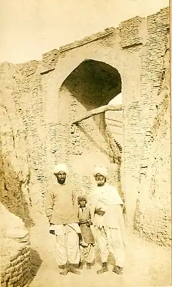 Two Sindhi men and a boy in Sindhi Suthan/Salwar, Pehran, Patka, Loi (Sindhi shawl), and cap and jacket.