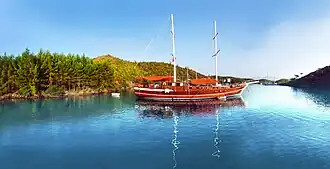 Traditional two-masted gulet visiting a cove in Gökova during a Blue Cruise