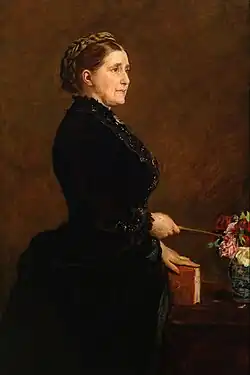 Painting of woman in profile wearing a black dress, holding a book in her left hand.