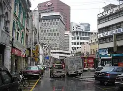 Jalan Tun H S Lee (High Street) in the old town of Kuala Lumpur, featuring a blend of old and new architecture.