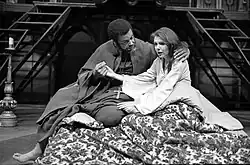 Black and white photograph of a Black man and white woman in theatrical costumes from Shakespeare's Othello