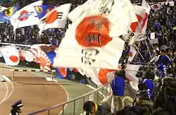 Japanese football fans wave a Rising Sun Flag during a Japan vs. Bosnia and Herzegovina match in January 2008