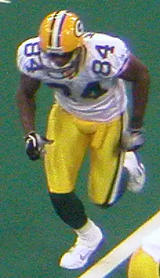 Javon Walker running on a football field in uniform