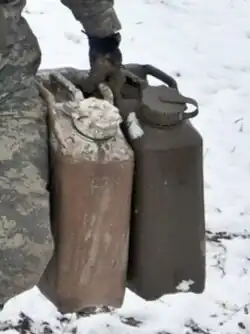 One hand holding two cans