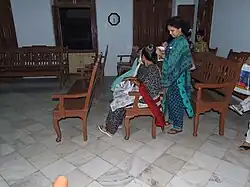 Indian Jewish women. One, seated, is wearing a kippah