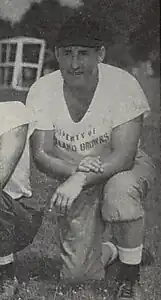 A picture of John Brickels kneeling on the grass from a 1946 Cleveland Browns game program