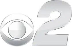 In silver, a CBS eye next to a slightly squished bold italic numeral 2